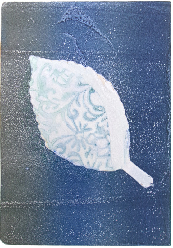 An abstract vertical image, with black to midnight blue gradient from left to right. A leaf shape interrupts the gradient as negative space in the center. A lacy pattern in indigo blue interrupts the negative space of the leaf.