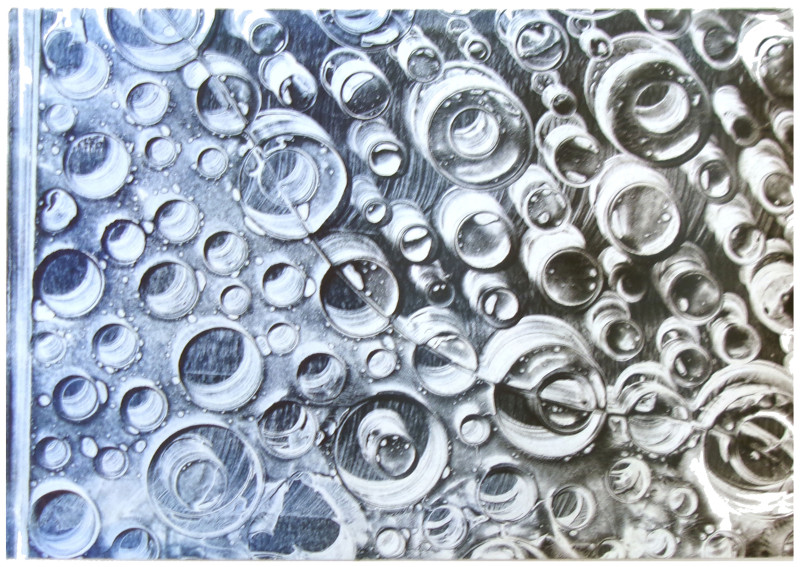 An abstract image in blue and black tones with blobby bubble shapes throughout. The colors travel in a gradient from blue to black from the left ot right.