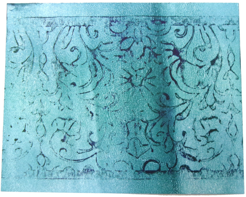An abstract image of a field of dark cyan, with an ornate lace-like pattern overprinted in black.
