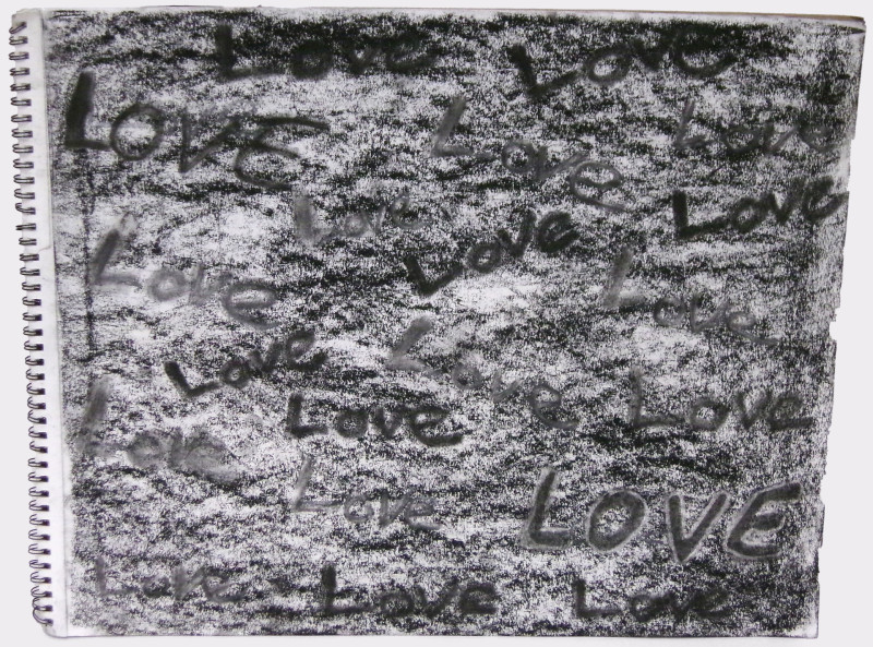 A drawing in a spiral notebook. Charcoal rubbing forms the background. The word 